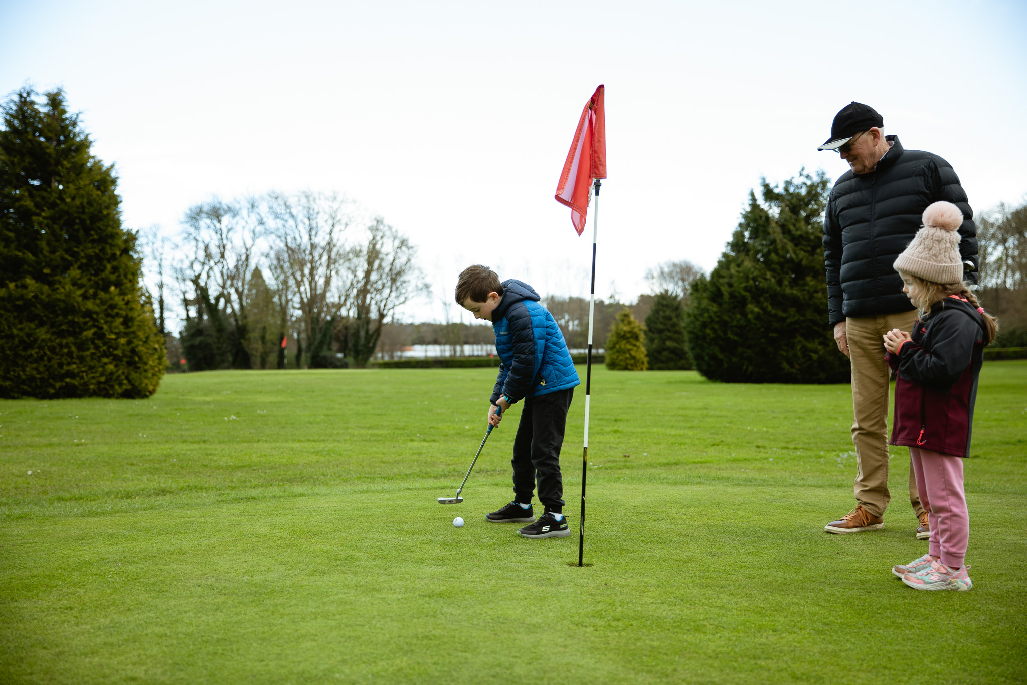 Family playing golf Family playing par 3 golf